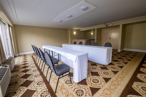 a conference room with a long table and chairs at Howard Johnson by Wyndham Fullerton/Anaheim Conference Cntr in Fullerton