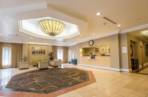 a living room filled with furniture and a large window at Howard Johnson by Wyndham Fullerton/Anaheim Conference Cntr in Fullerton