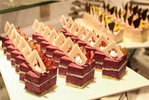 a bunch of desserts sitting on a table at Kunshan International Hotel in Kunshan