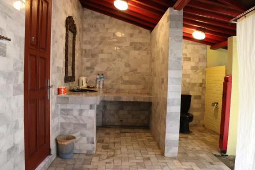 a bathroom with a sink and a toilet at Puri Bunga Beach Cottages in Senggigi 