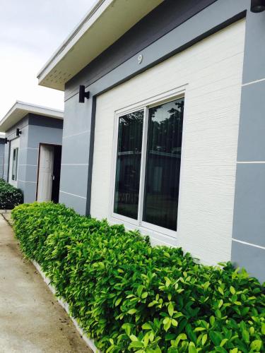 a house with a window on the side of it at Relax Resort in Nakhon Sawan