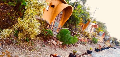 a building on the side of a hill with plants at Kamp Aninipot in Siquijor
