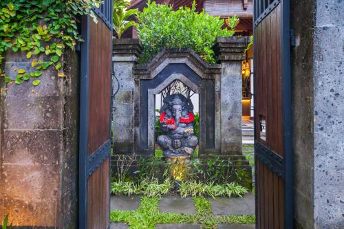 a statue of a woman sitting on top of a fire hydrant at Luxury 3BR Infinity Jungle View Aashaya Villa Ubud in Ubud