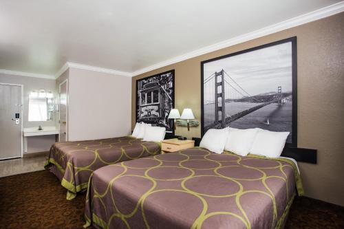a hotel room with two beds and a bridge picture at Super 8 by Wyndham Vacaville in Vacaville