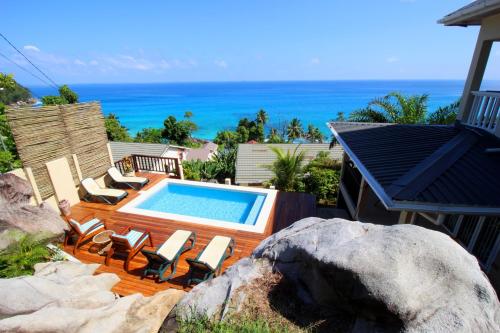 a swimming pool with chairs and the ocean in the background at Kaz Bulinger in Machabee