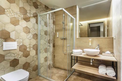 a bathroom with a shower and a toilet and a sink at Avenue Legerova 19 in Prague