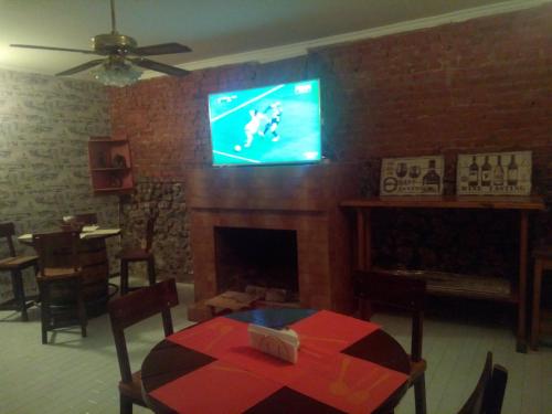 a living room with a tv above a fireplace at Mia B&B Tbilisi in Tbilisi City