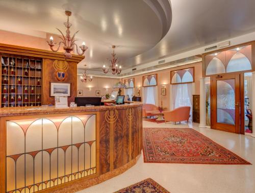a lobby with a bar with a wine tasting room at Hotel San Giusto in Trieste