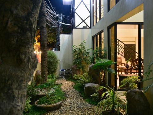 a garden with plants and trees in a building at Anahaw Apartments Whitebeach in Boracay