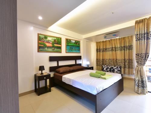 um quarto com uma cama grande num quarto em Anahaw Apartments Whitebeach em Boracay