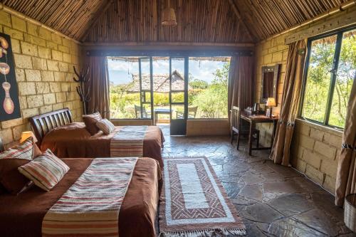 Postel nebo postele na pokoji v ubytování Rhino Watch Safarilodge