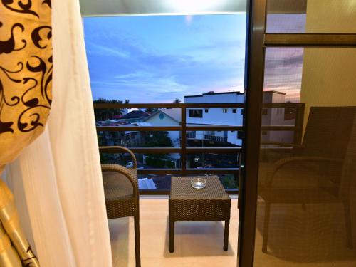 a view of a balcony with a table and chairs at Anahaw Apartments Whitebeach in Boracay