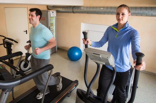 two men on exercise bikes in a gym at Hotel & Restaurant Goldener Pflug in Ludwigsburg