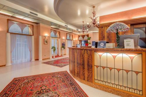 a lobby with a reception desk and a rug at Hotel San Giusto in Trieste