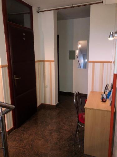 a room with a door and a desk and a chair at Smještaj Natalija in Osijek