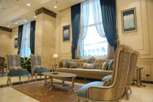 a living room with a couch and chairs and a window at Gewan Hotel Cairo in Cairo