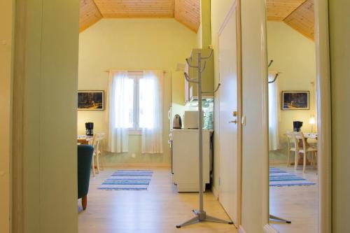 a kitchen with a refrigerator and a dining room at Herranniemi Guesthouse in Vuonislahti
