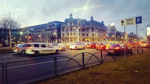 a busy city street filled with lots of traffic at Sleep Inn Hostel in Bucharest