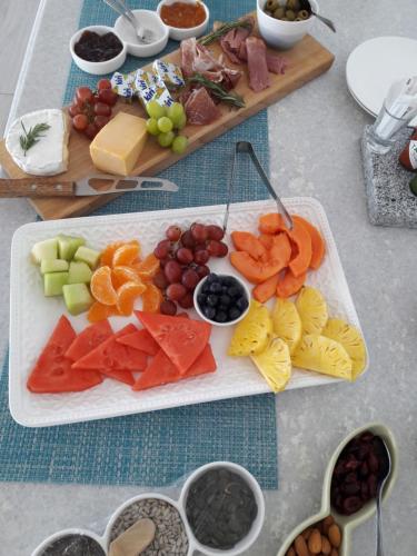a tray of different types of food on a table at Ocean Vista Boutique Guest House in Durban