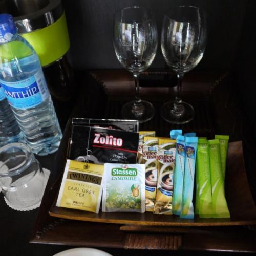 a table with a tray of snacks and wine glasses at GRANMONTE Wine Cottage in Phayayen