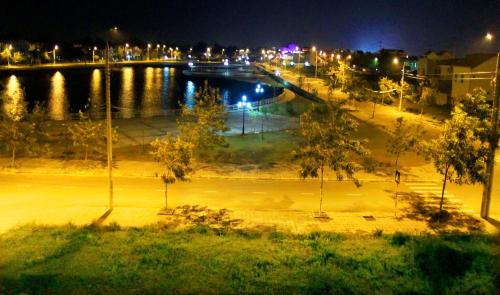 a view of a river at night with a bridge at Melody Boutique Villa Hoi An in Hoi An