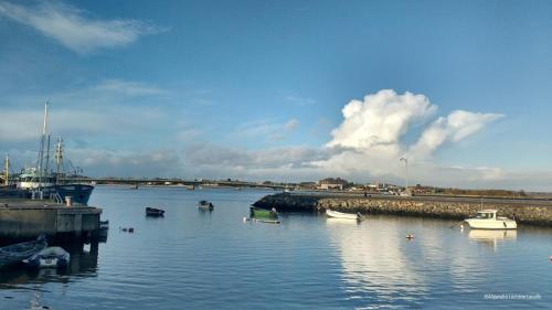 a group of boats in a body of water at Ula Cottage in Saint Helens
