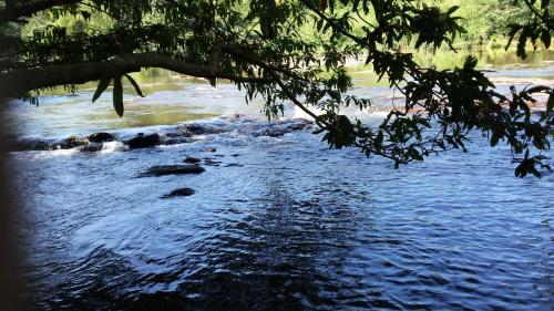 a river with some rocks in the water at Nature's Hideout Holiday Home in Mirigama