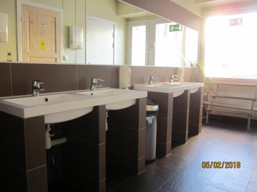 a bathroom with two sinks and a large mirror at Uppsala City Hostel in Uppsala