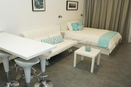 ラスパルマス・デ・グランカナリアにあるAqua Las Canterasのベッド2台とテーブルが備わるホテルルームです。