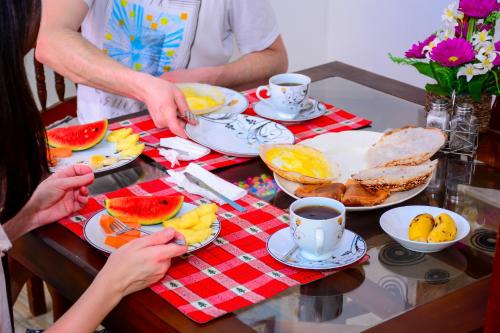 a group of people standing around a table with food at Marcelin Family Villa in Negombo