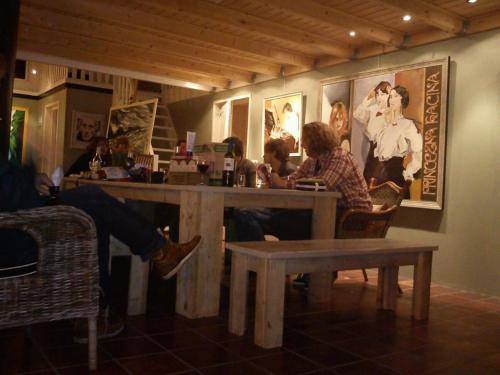 a group of people sitting at a table in a restaurant at De Galeriet Giethoorn in Giethoorn