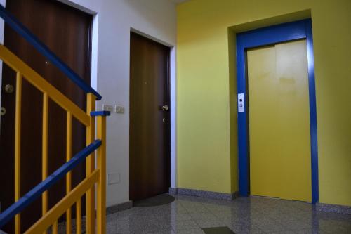 a hallway with two elevators and two doors at Relax House in Giardini Naxos