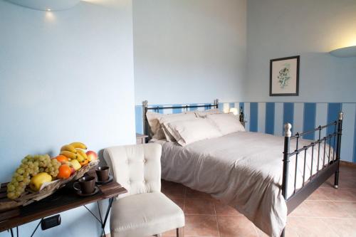 a bedroom with a bed with a tray of fruit at Affittacamere Il Torchio in Pianfei