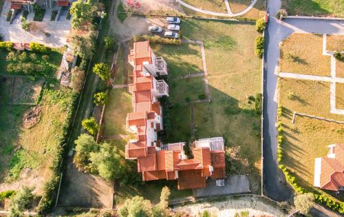 an overhead view of a house with red roof at Sunset Villas in Possidi