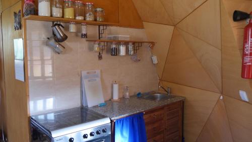 a small kitchen with a sink and a stove at vale das cupulas in Figueiró dos Vinhos