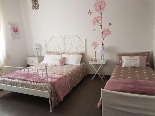 Ein Bett oder Betten in einem Zimmer der Unterkunft B&B La Perla Bianca