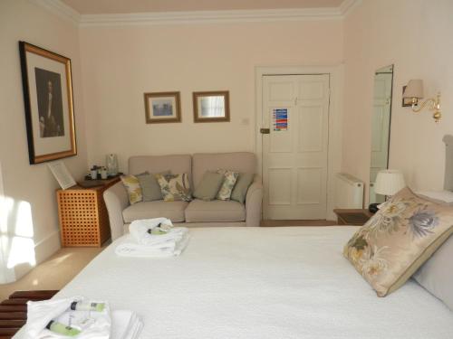 a living room with a bed and a couch at Brocks in Bath