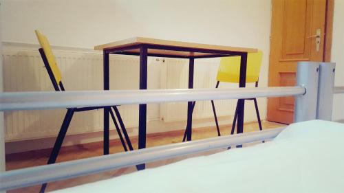 a table and a chair in a room at Sleep Inn Hostel in Bucharest