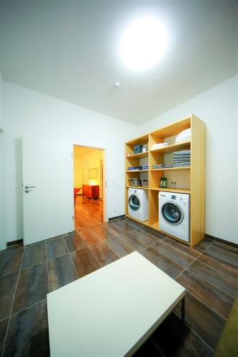 a living room with a washer and dryer at Connie's House Holiday Apartment in Heidelberg