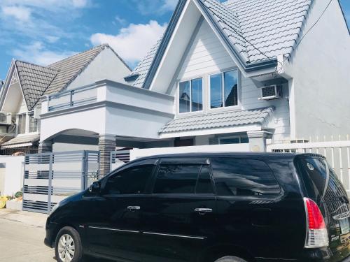 a black van parked in front of a house at Hillary Timog Park Homes in Angeles