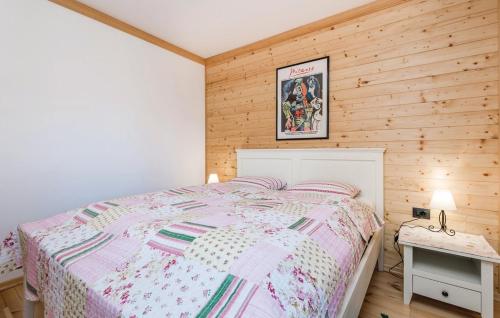 a bedroom with a bed and a wooden wall at Apartment Vila Lokve in Lokve