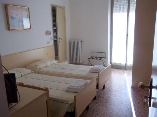 Ένα ή περισσότερα κρεβάτια σε δωμάτιο στο Hotel Italia