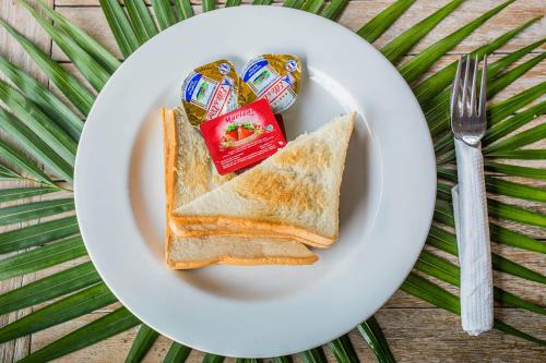 a white plate with two slices of toast and jam at The Syron Huts Lembongan in Nusa Lembongan
