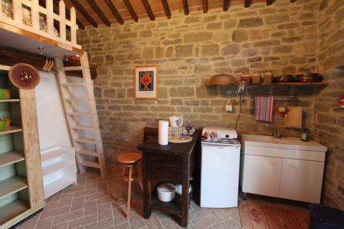 a small kitchen with a sink and a stove at La Locanda Della Campanara in Santa Sofia