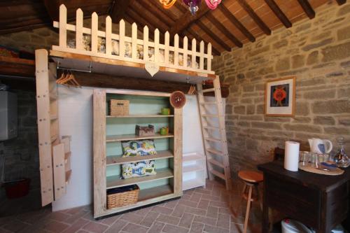 a room with a bunk bed and a cupboard at La Locanda Della Campanara in Santa Sofia
