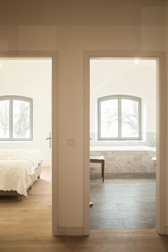 a bedroom with two beds and two windows at Gutshaus Üselitz in Poseritz