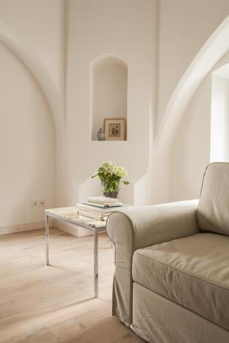 a living room with a couch and a table at Gutshaus Üselitz in Poseritz