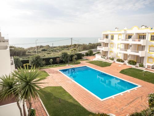 an apartment with a swimming pool in front of a building at Ericeira Sea View - Mar à Vista in Ericeira