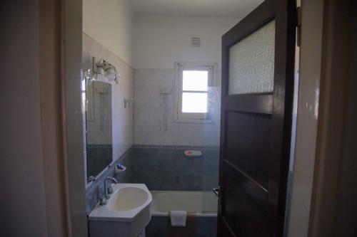 a bathroom with a sink and a toilet and a tub at La Posada del Mar in Miramar