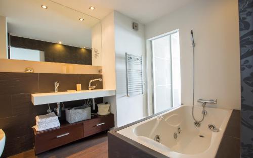 a bathroom with a large tub and a sink at Gava Beach 1st Line in Gavà